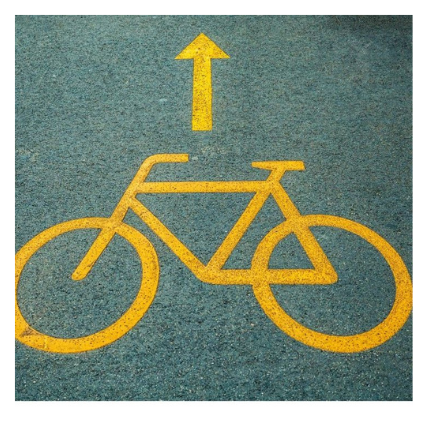 Yellow Bicycle and arrow painted in a road. 