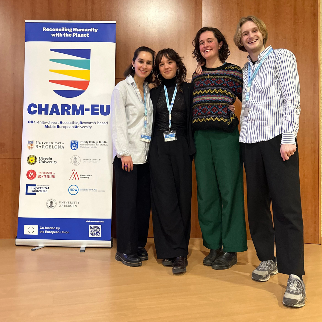 A capstone group of CHARM-EU students posing in front of the CHARM-EU roll-up after finishing their presentation. 
