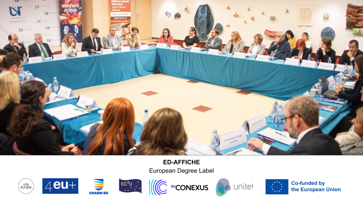 Big round table with approximately 27 persons  discussing about the European Degree label - ED-AFFICHE and the logos from the full partners UnaEuropa, 4EU+, CHARM_EU, EC2U, EU-CONEXUS, Unite! and the Co-funded by the European Union logo